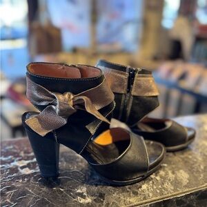 Hispanitas Black Open-Toe High Heel Sandals with Metallic Bow Accent